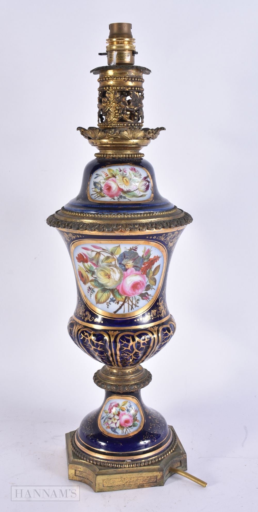 A LARGE 19TH CENTURY FRENCH PARIS PORCELAIN LAMP painted with flowers upon a rich blue ground. 50 cm: A LARGE 19TH CENTURY FRENCH PARIS PORCELAIN LAMP painted with flowers upon a rich blue ground. 50 cm high.