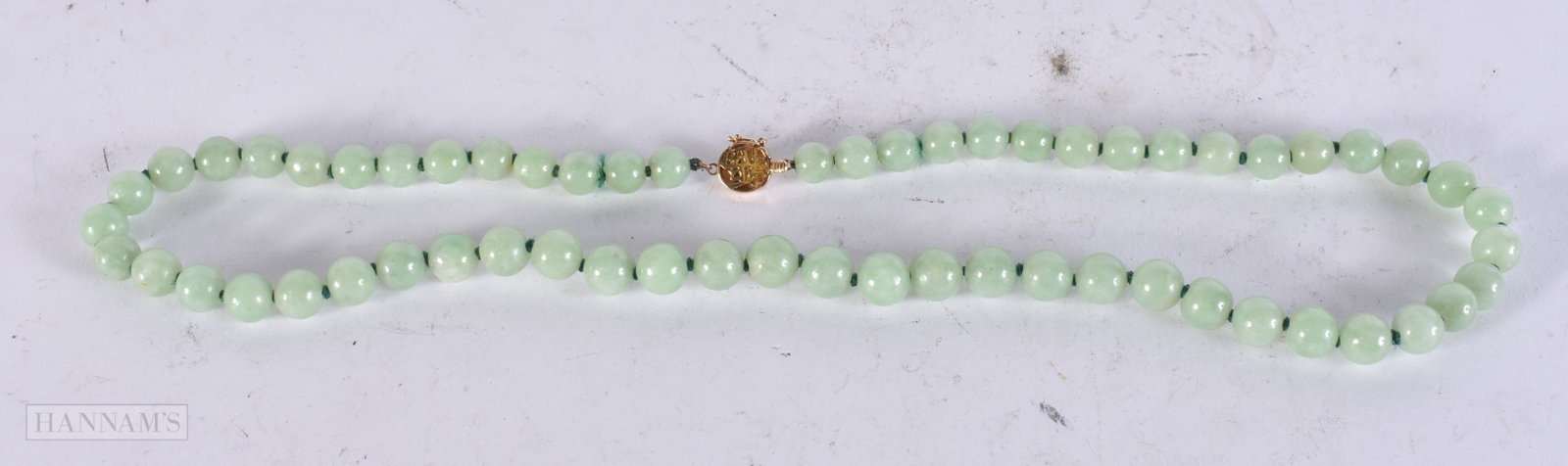 A 14CT GOLD CHINESE JADEITE NECKLACE. 44 cm long.: A 14CT GOLD CHINESE JADEITE NECKLACE. 44 cm long.