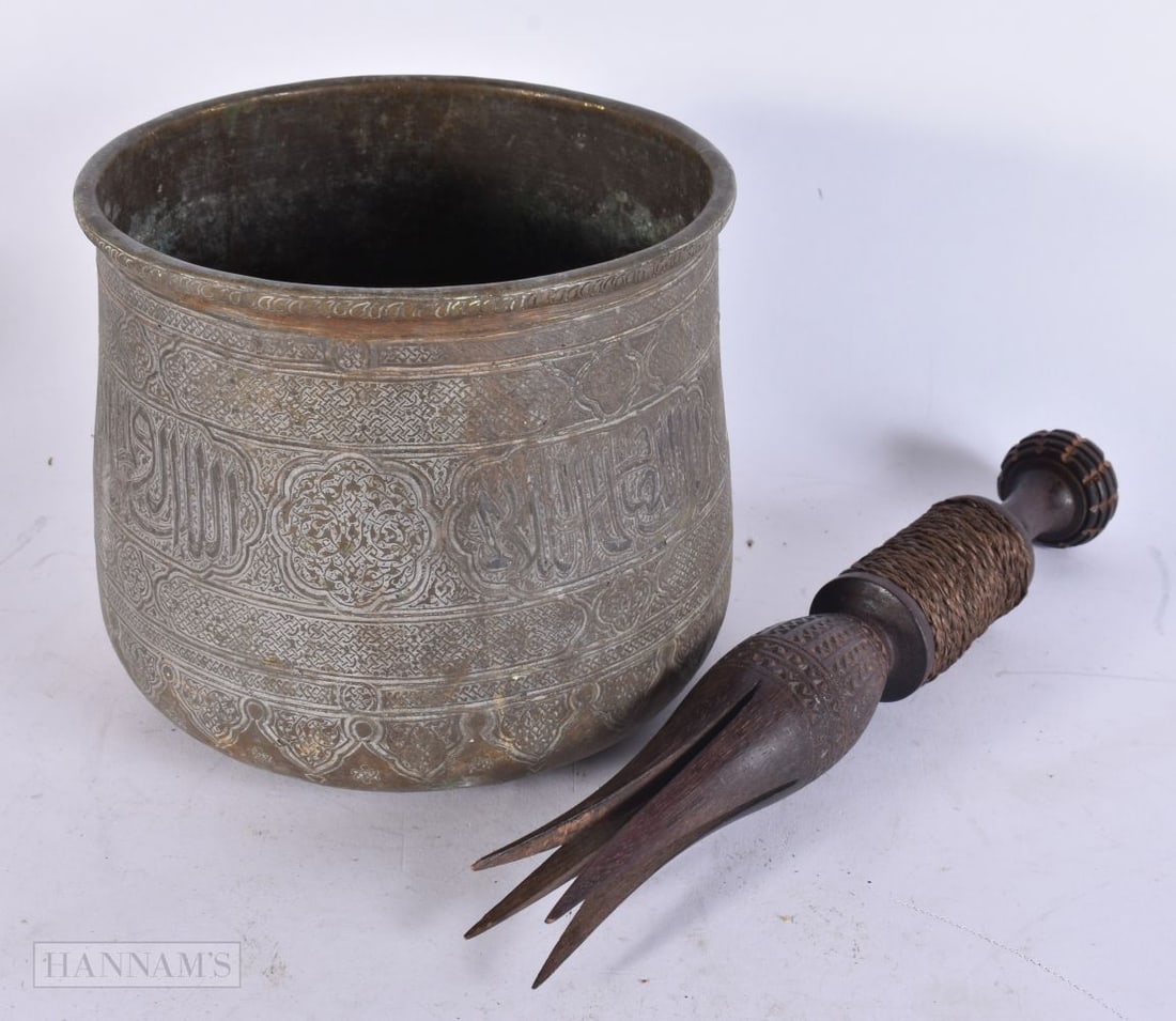 A 19TH CENTURY ISLAMIC SILVER INLAID COPPER ALLOY PLANTER together with a tribal carved wood vessel.: A 19TH CENTURY ISLAMIC SILVER INLAID COPPER ALLOY PLANTER together with a tribal carved wood vessel. Largest 30 cm long. (2)