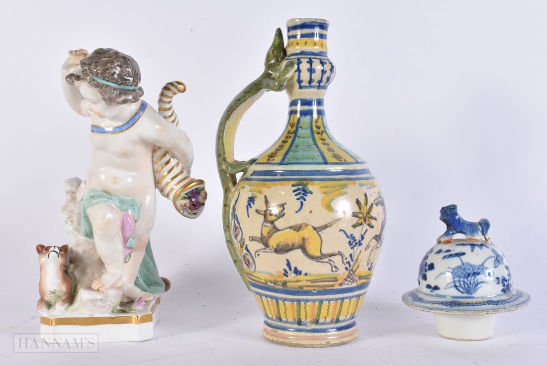 AN ANTIQUE SPANISH FAIENCE POTTERY JUG together with a German porcelain figure & a Chinese Qing lid. (1 of 3)