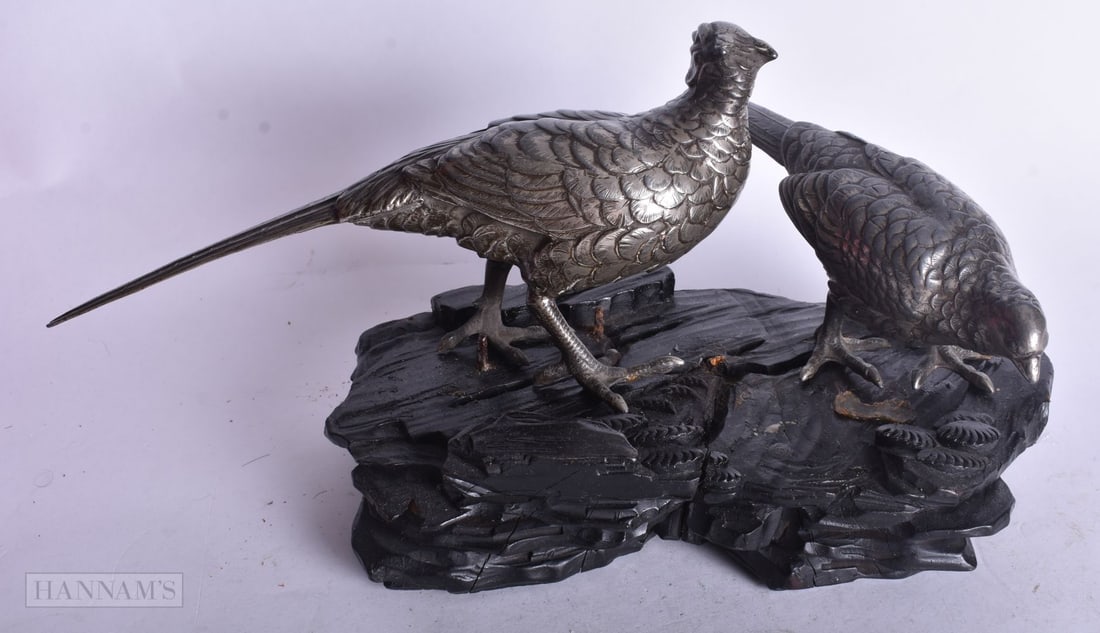TWO JAPANESE WHITE METAL OKIMONOS OF PHEASANTS ON A WOOD BASE. 10 X 24 cm. (3): TWO JAPANESE WHITE METAL OKIMONOS OF PHEASANTS ON A WOOD BASE. 10 X 24 cm. (3)