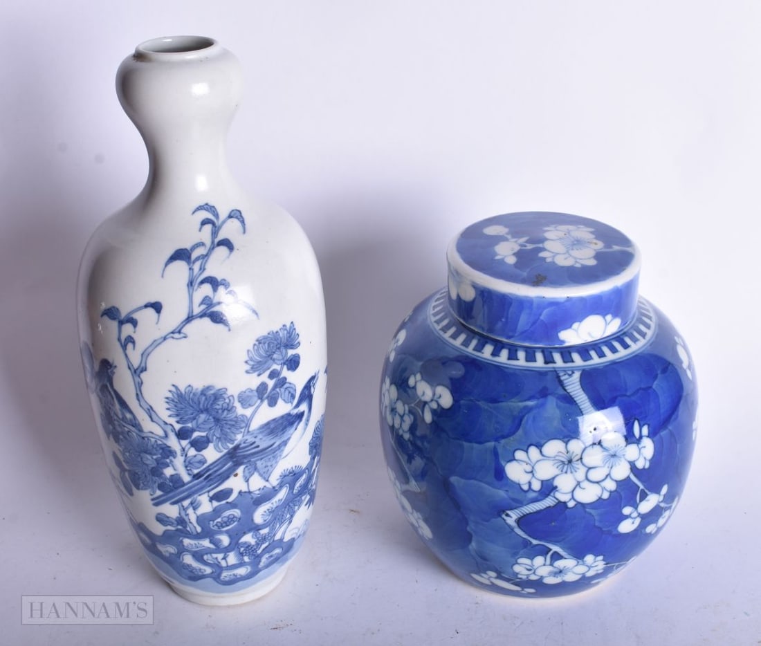 A CHINESE BLUE AND WHITE GARLIC NECK VASE TOGETHER WITH A BLUE AND WHITE PRUNUS GINGER JAR. 24 cm hi: A CHINESE BLUE AND WHITE GARLIC NECK VASE TOGETHER WITH A BLUE AND WHITE PRUNUS GINGER JAR. 24 cm high. (2)
