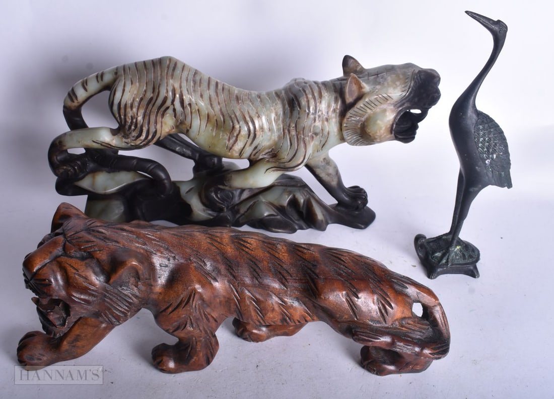 A CARVED SOAPSTONE FIGURE OF A TIGER TOGETHER WITH CARVED WOOD TIGER AND A BRONZE CRANE, 17 x 31 cm.: A CARVED SOAPSTONE FIGURE OF A TIGER TOGETHER WITH CARVED WOOD TIGER AND A BRONZE CRANE, 17 x 31 cm. (3)
