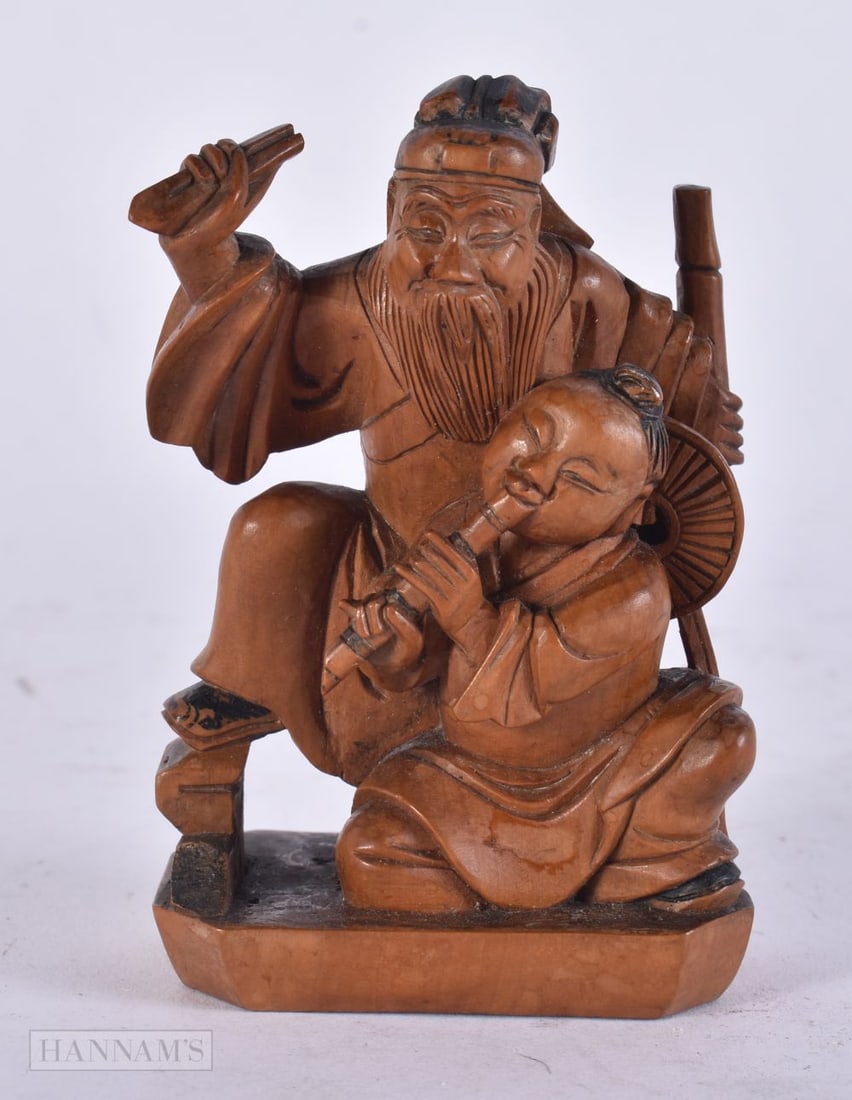 A CHINESE QING DYNASTY CARVED BOXWOOD FIGURE OF A MALE modelled beside a musician. 8 cm x 5.5 cm. (1 of 3)