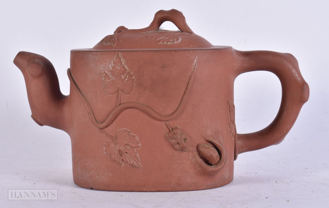 A LATE 19TH CENTURY CHINESE YIXING POTTERY TEAPOT AND COVER Late Qing. 18 cm wide. (1 of 4)