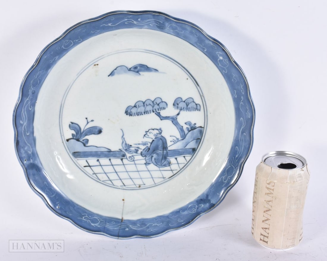 A LARGE 18TH CENTURY JAPANESE EDO PERIOD BLUE AND WHITE PORCELAIN DISH painted a scholar in a landsc: A LARGE 18TH CENTURY JAPANESE EDO PERIOD BLUE AND WHITE PORCELAIN DISH painted a scholar in a landscape. 30 cm wide.