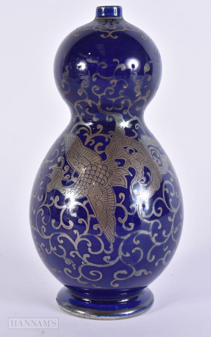 A LATE 19TH CENTURY JAPANESE MEIJI PERIOD SILVER OVERLAID GOURD VASE decorated with a bird amongst f: A LATE 19TH CENTURY JAPANESE MEIJI PERIOD SILVER OVERLAID GOURD VASE decorated with a bird amongst foliage. 16.5 cm high.