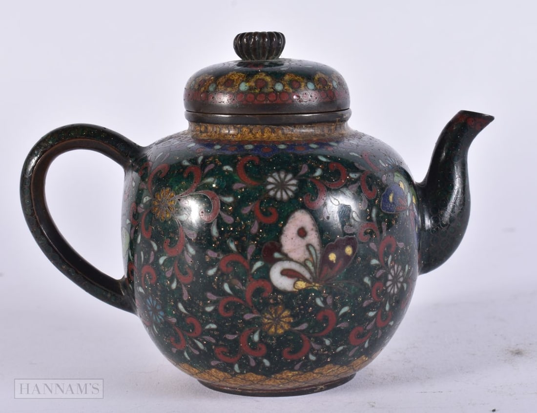 A LATE 19TH CENTURY JAPANESE MEIJI PERIOD CLOISONNE ENAMEL TEAPOT decorated with flowers and insects: A LATE 19TH CENTURY JAPANESE MEIJI PERIOD CLOISONNE ENAMEL TEAPOT decorated with flowers and insects. 10 cm wide.