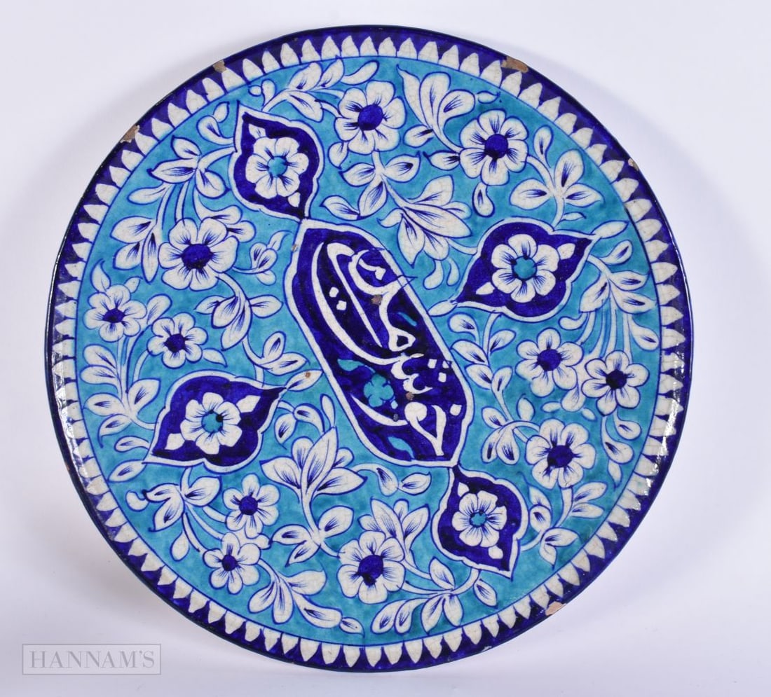 A MIDDLE EASTERN PERSIAN ISLAMIC BLUE AND WHITE POTTERY PLATE. 29 cm wide. (1 of 3)