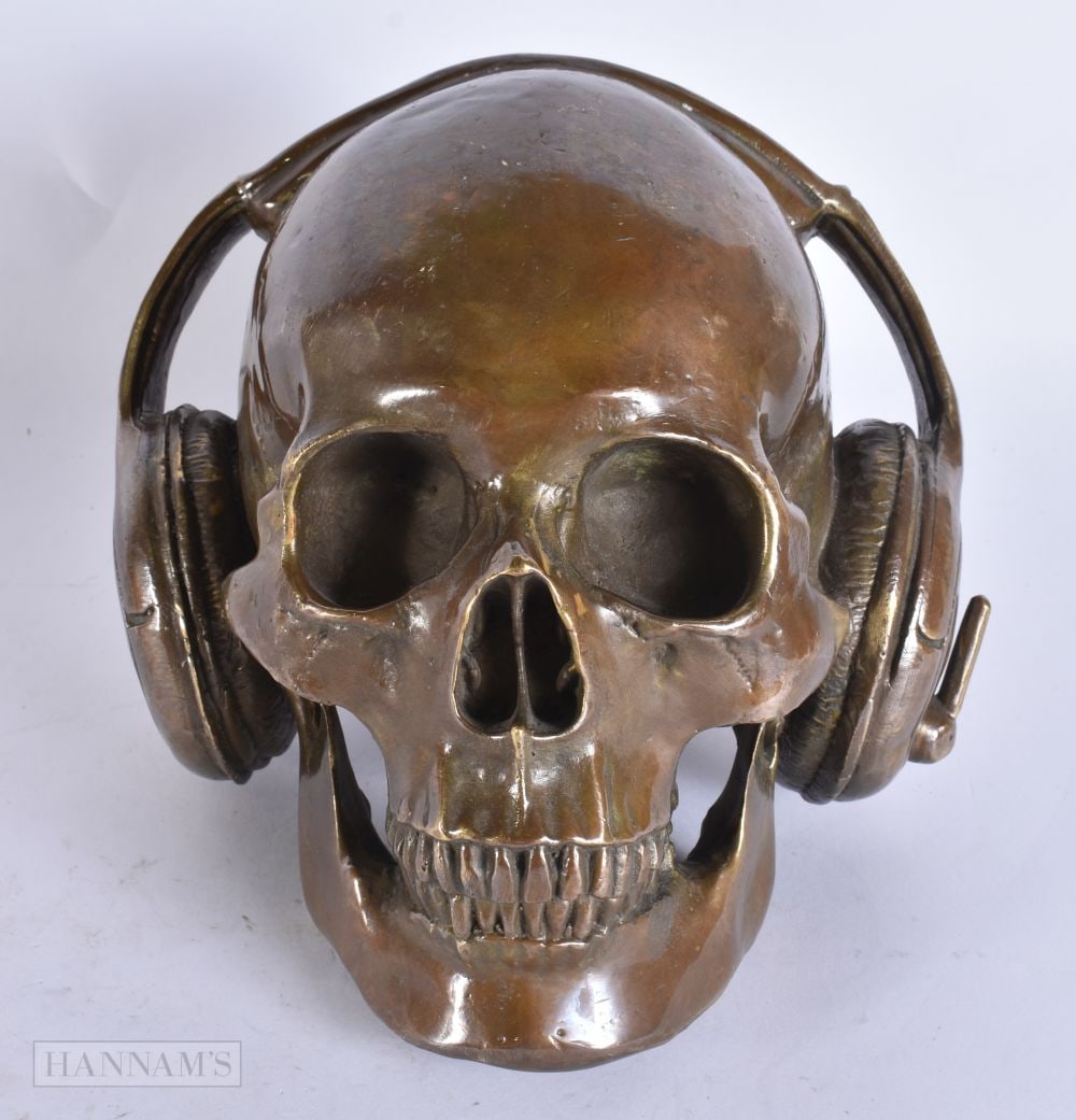 A BRONZE DJ SKULL AND HEADPHONES. 19 cm x 15 cm.: A BRONZE DJ SKULL AND HEADPHONES. 19 cm x 15 cm.