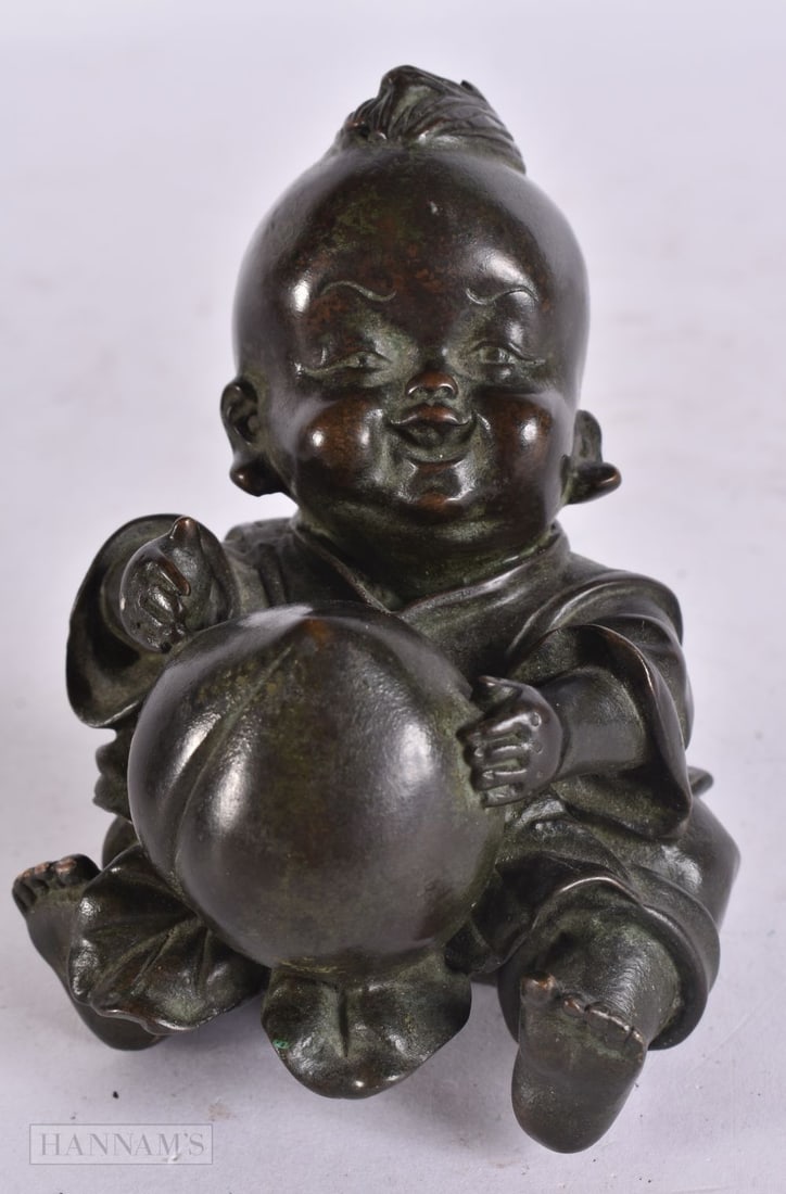 A CHINESE BRONZE BOY. 8 cm x 5.5 cm. (1 of 5)