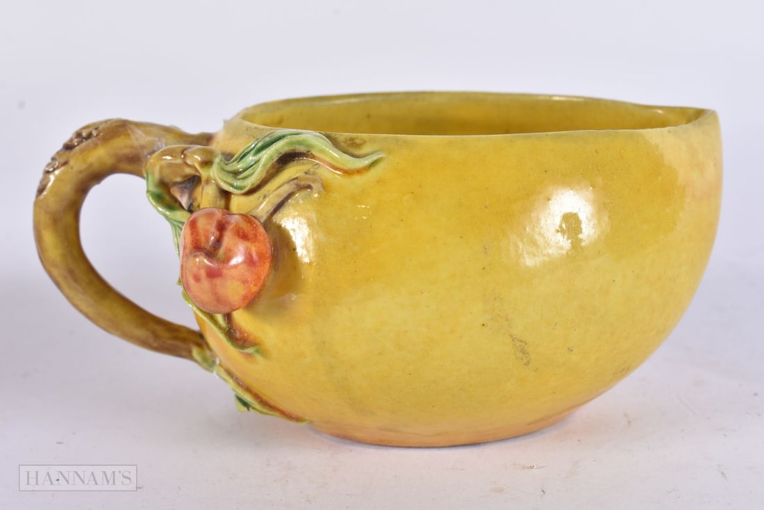A CHINESE YELLOW GLAZED CUP. 13 cm wide.: A CHINESE YELLOW GLAZED CUP. 13 cm wide.