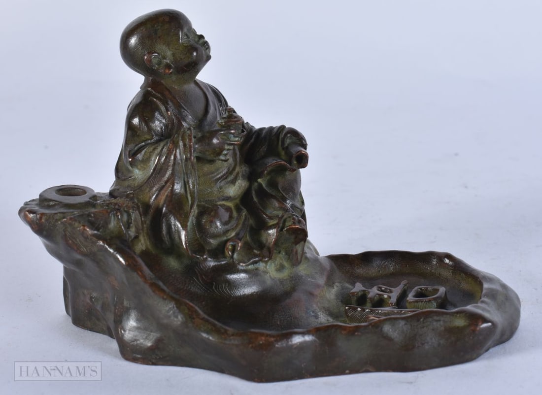 A CHINESE BRONZE BUDDHA. 12 cm wide.: A CHINESE BRONZE BUDDHA. 12 cm wide.