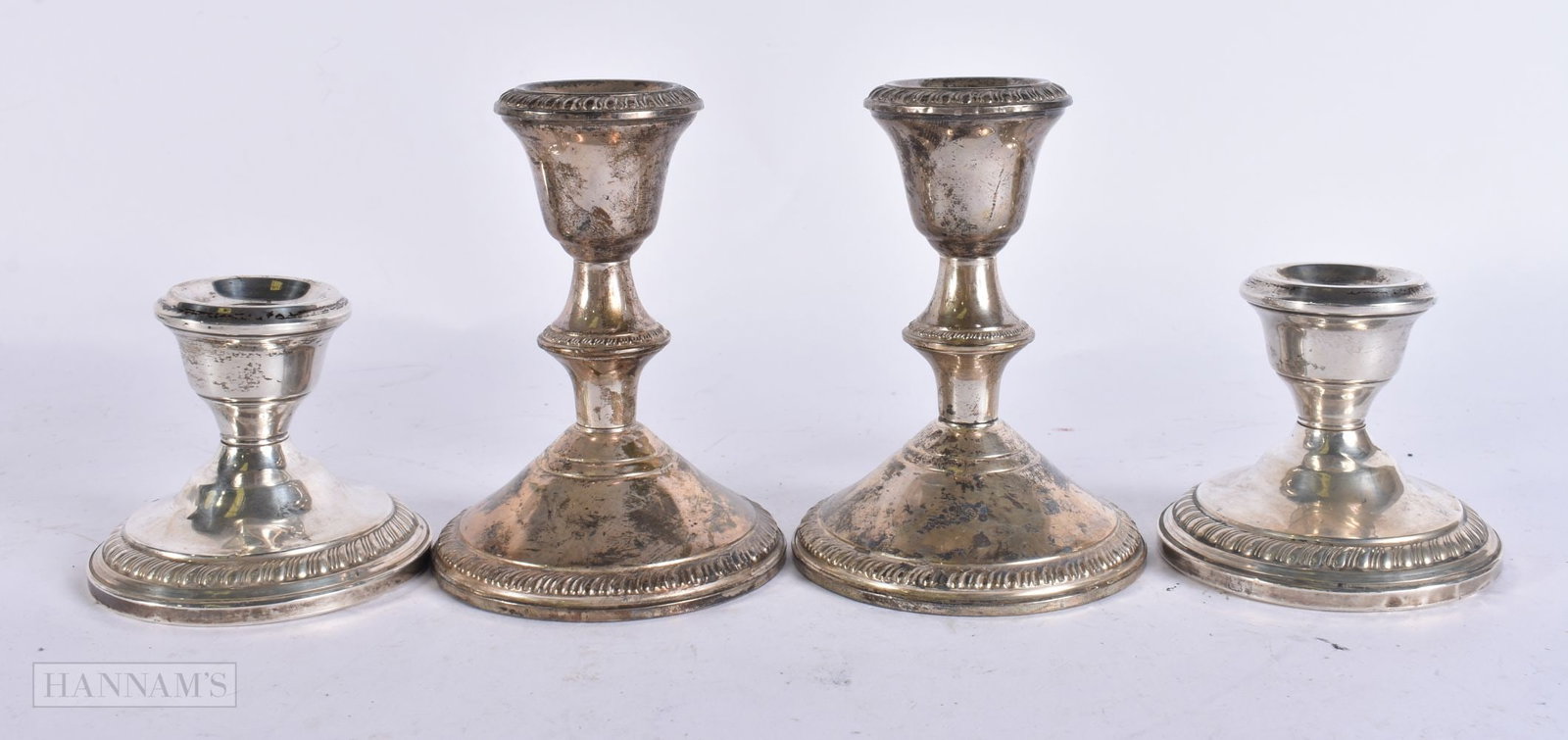FOUR PAIRS OF SILVER CANDLESTICKS. 750 grams overall. Largest 10 cm high. (4) (1 of 7)