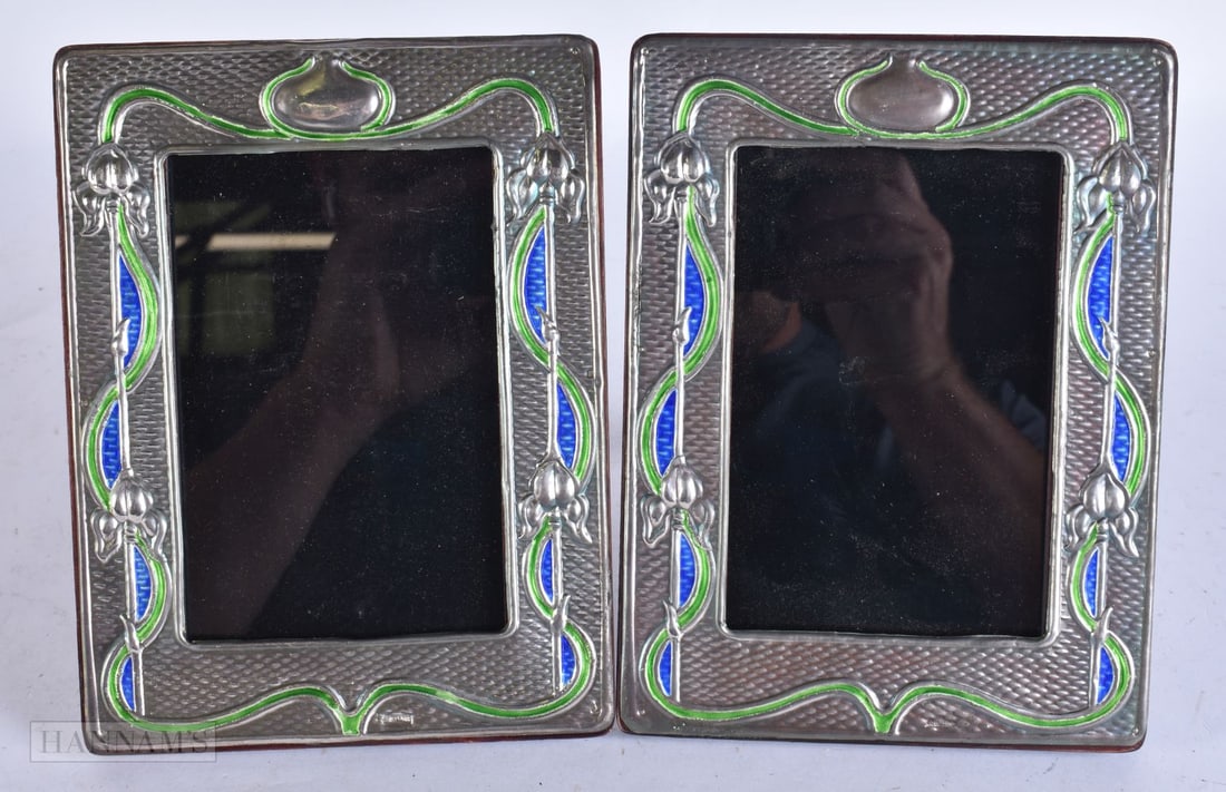 A PAIR OF SILVER AND ENAMEL PHOTOGRAPH FRAMES. 20 cm x 15 cm. (1 of 5)