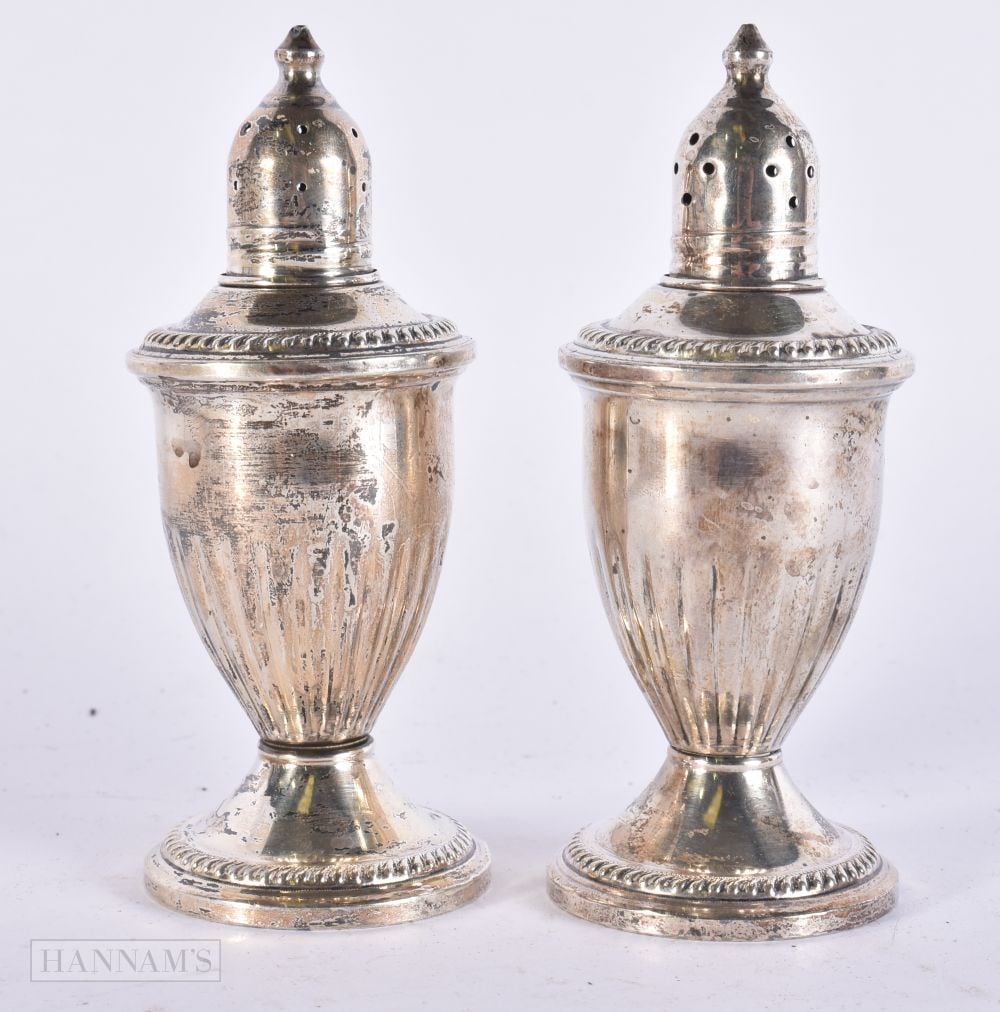 A PAIR OF SILVER CONDIMENTS. 271 grams overall. 11.5 cm high. (1 of 4)