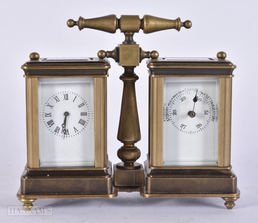 A DOUBLE DIAL CLOCK. 12 cm x 10 cm. (1 of 2)