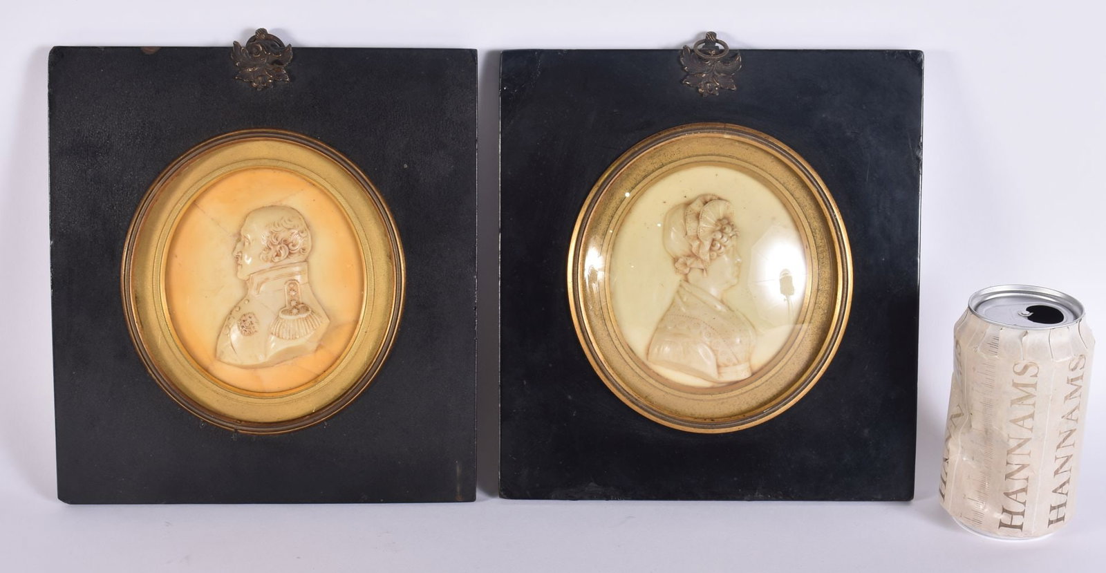 AN UNUSUALLY LARGE PAIR OF 19TH CENTURY WAX PORTRAITS contained within ebonised frames. 24 cm x 19 c: AN UNUSUALLY LARGE PAIR OF 19TH CENTURY WAX PORTRAITS contained within ebonised frames. 24 cm x 19 cm.