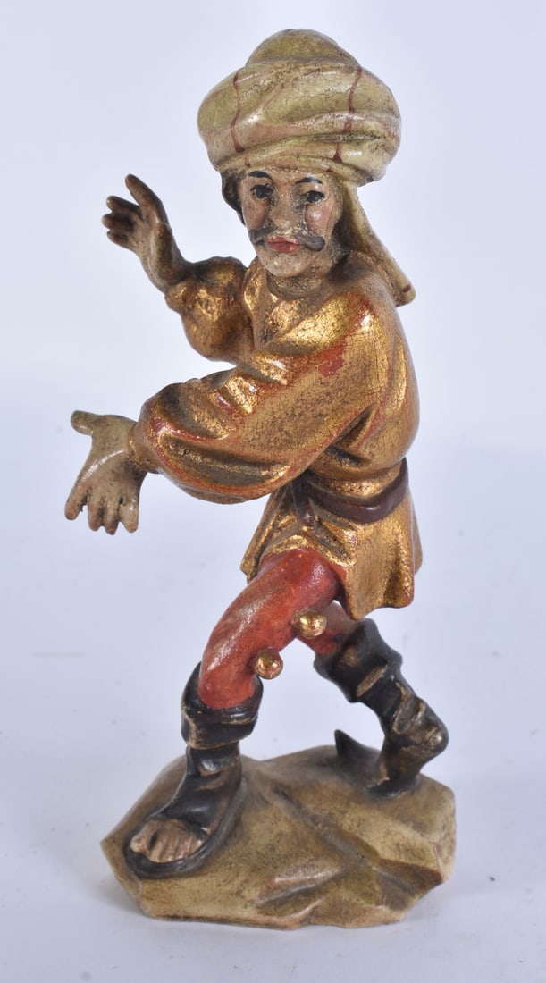 A 19TH CENTURY TURKISH POLYCHROMED WOOD FIGURE OF A MALE modelled upon a rocky outcrop. 17.5 cm high: A 19TH CENTURY TURKISH POLYCHROMED WOOD FIGURE OF A MALE modelled upon a rocky outcrop. 17.5 cm high.