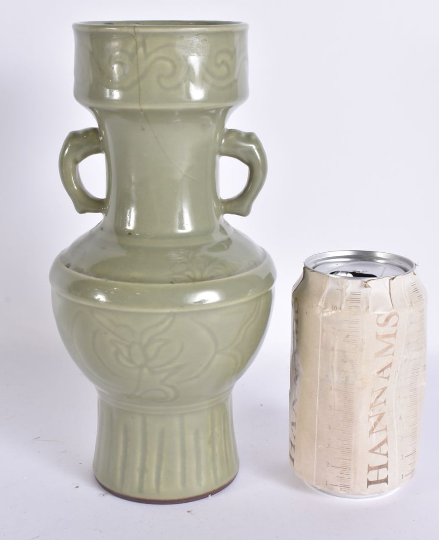 A CHINESE QING DYNASTY LONGQUAN CELADON TWIN HANDLED VASE incised with foliage. 23 cm high.: A CHINESE QING DYNASTY LONGQUAN CELADON TWIN HANDLED VASE incised with foliage. 23 cm high.