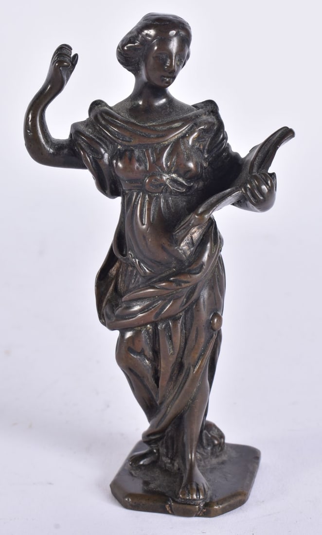 AN EARLY 18TH CENTURY BRONZE FIGURE OF A FEMALE modelled holding an open book. 12.75 cm high.: AN EARLY 18TH CENTURY BRONZE FIGURE OF A FEMALE modelled holding an open book. 12.75 cm high.