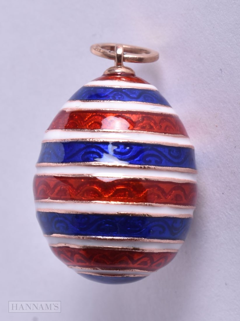 A 14CT GOLD ENAMEL EGG. 12.7 grams. 2.5 cm x 1.75 cm. (1 of 3)