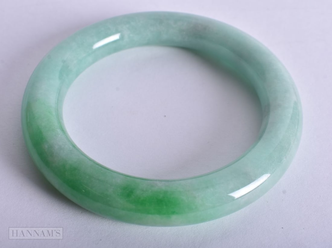 A CHINESE BANGLE. 5.75 cm wide. (1 of 2)