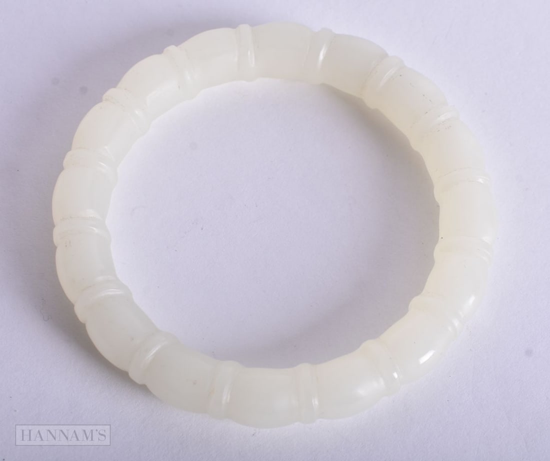 A CHINESE RIBBED JADE BANGLE. 6 cm wide. (1 of 2)