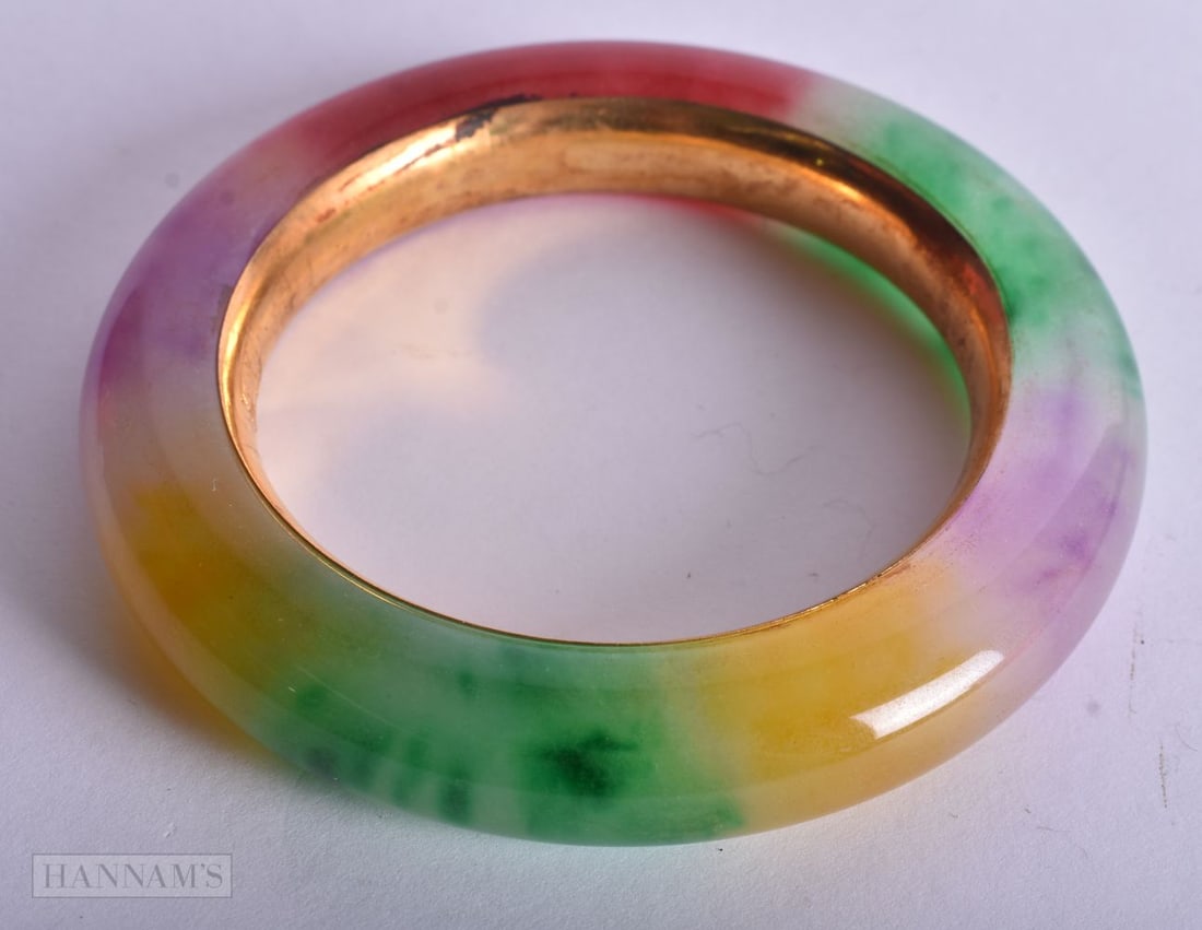 A CHINESE YELLOW METAL JADE BANGLE. 107 grams. 6 cm internal diameter. (1 of 2)