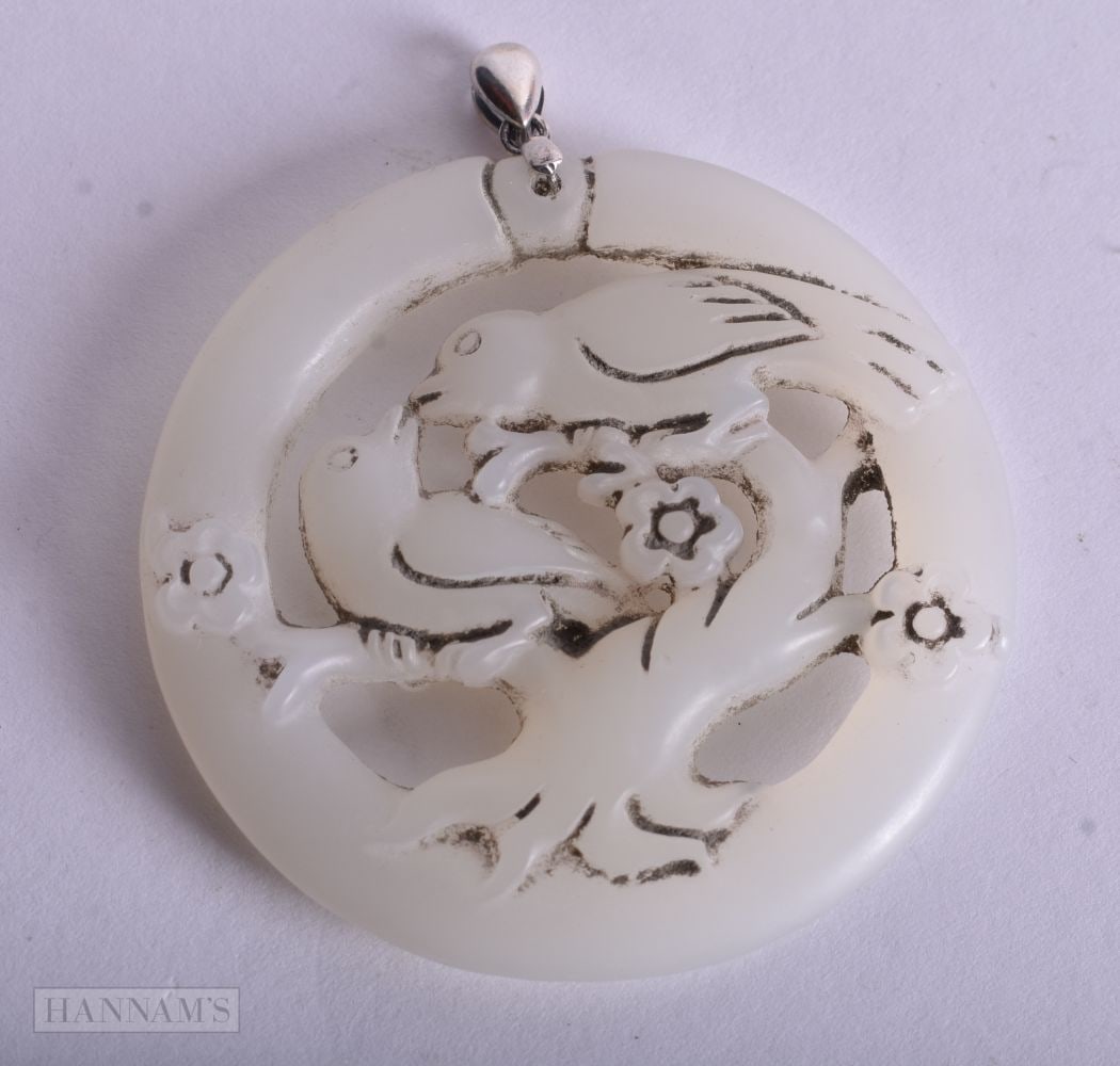 A CHINESE SILVER MOUNTED PENDANT. 5.25 cm wide.: A CHINESE SILVER MOUNTED PENDANT. 5.25 cm wide.