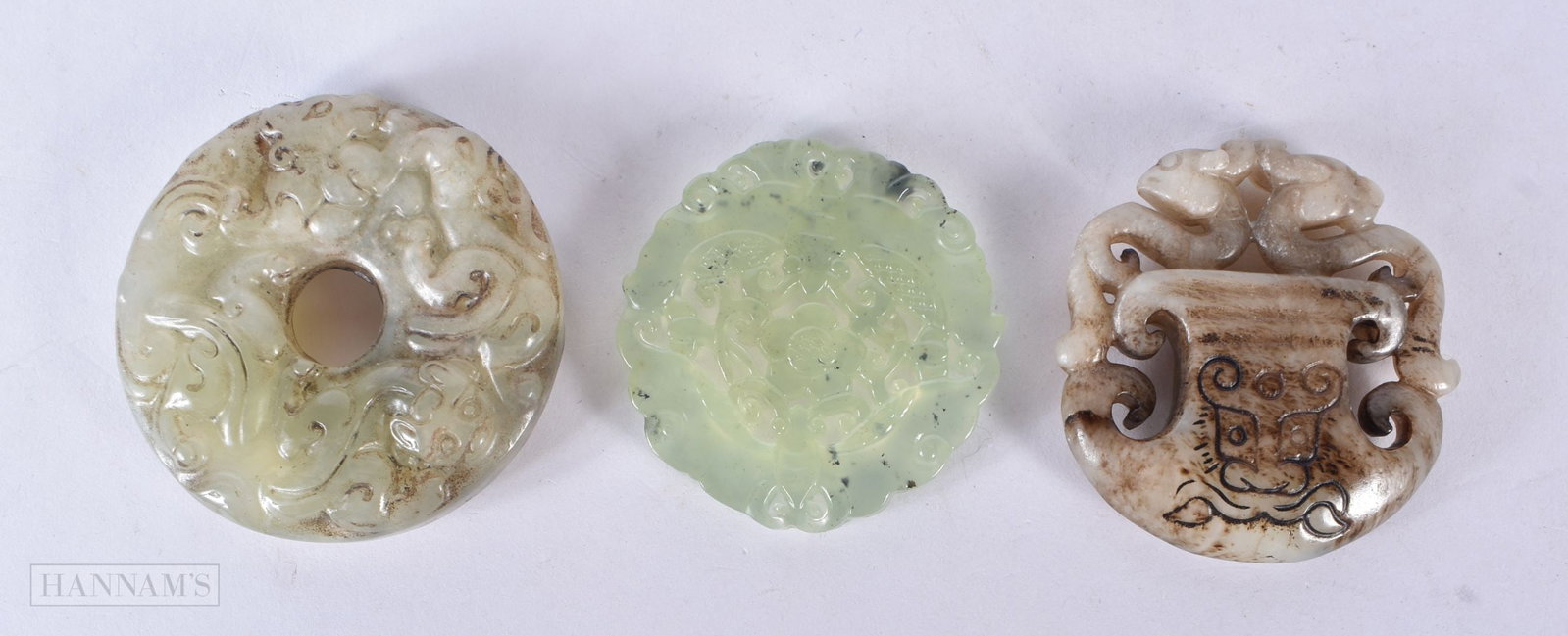 THREE CHINESE JADES. 5.5 cm wide. (3) (1 of 2)