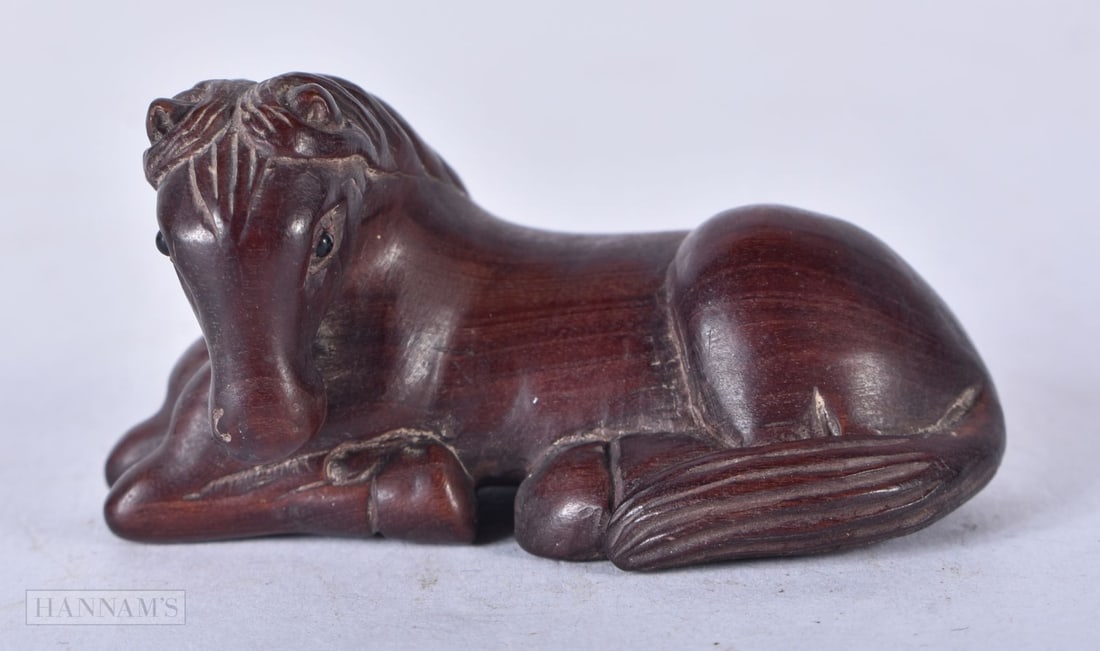 A JAPANESE WOOD NETSUKE. 5 cm x 3 cm. (1 of 3)