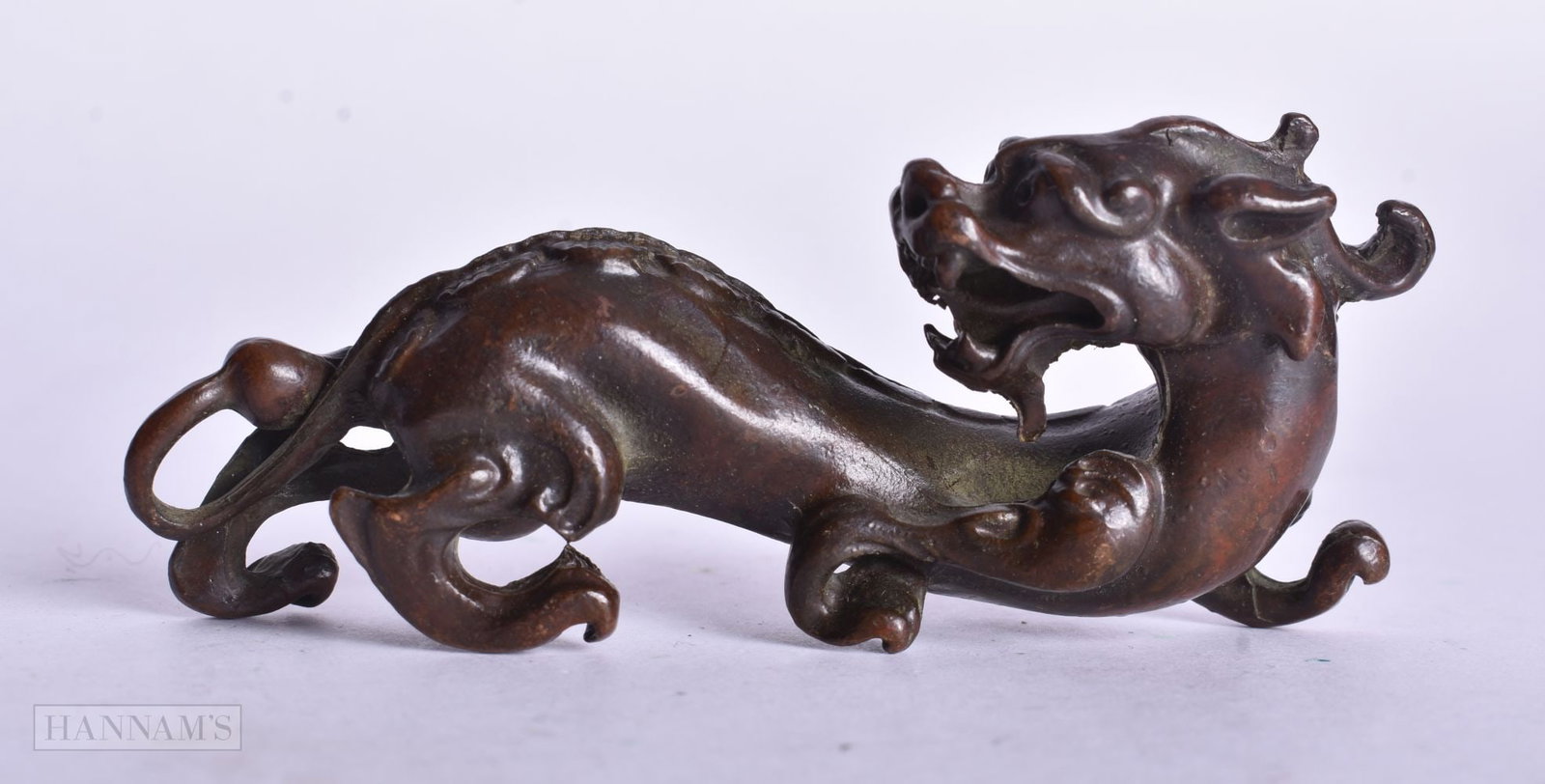 A CHINESE BRONZE BEAST. 9 cm x 4 cm.: A CHINESE BRONZE BEAST. 9 cm x 4 cm.