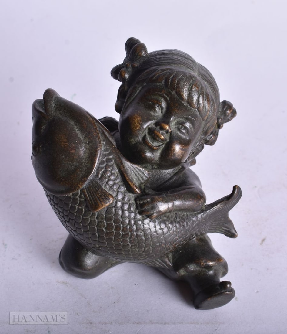 A CHINESE BRONZE BOY AND FISH. 7.5 cm x 7 cm.: A CHINESE BRONZE BOY AND FISH. 7.5 cm x 7 cm.