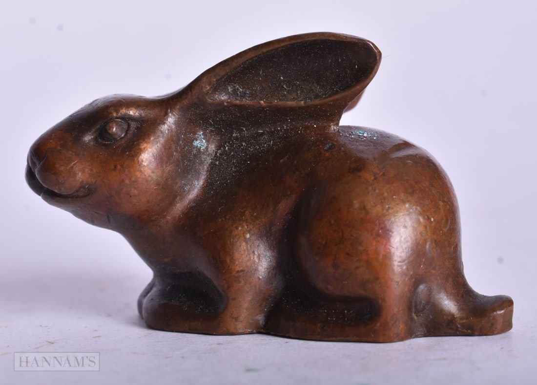 A CHINESE BRONZE RABBIT. 4.75 cm x 2.5 cm. (1 of 4)