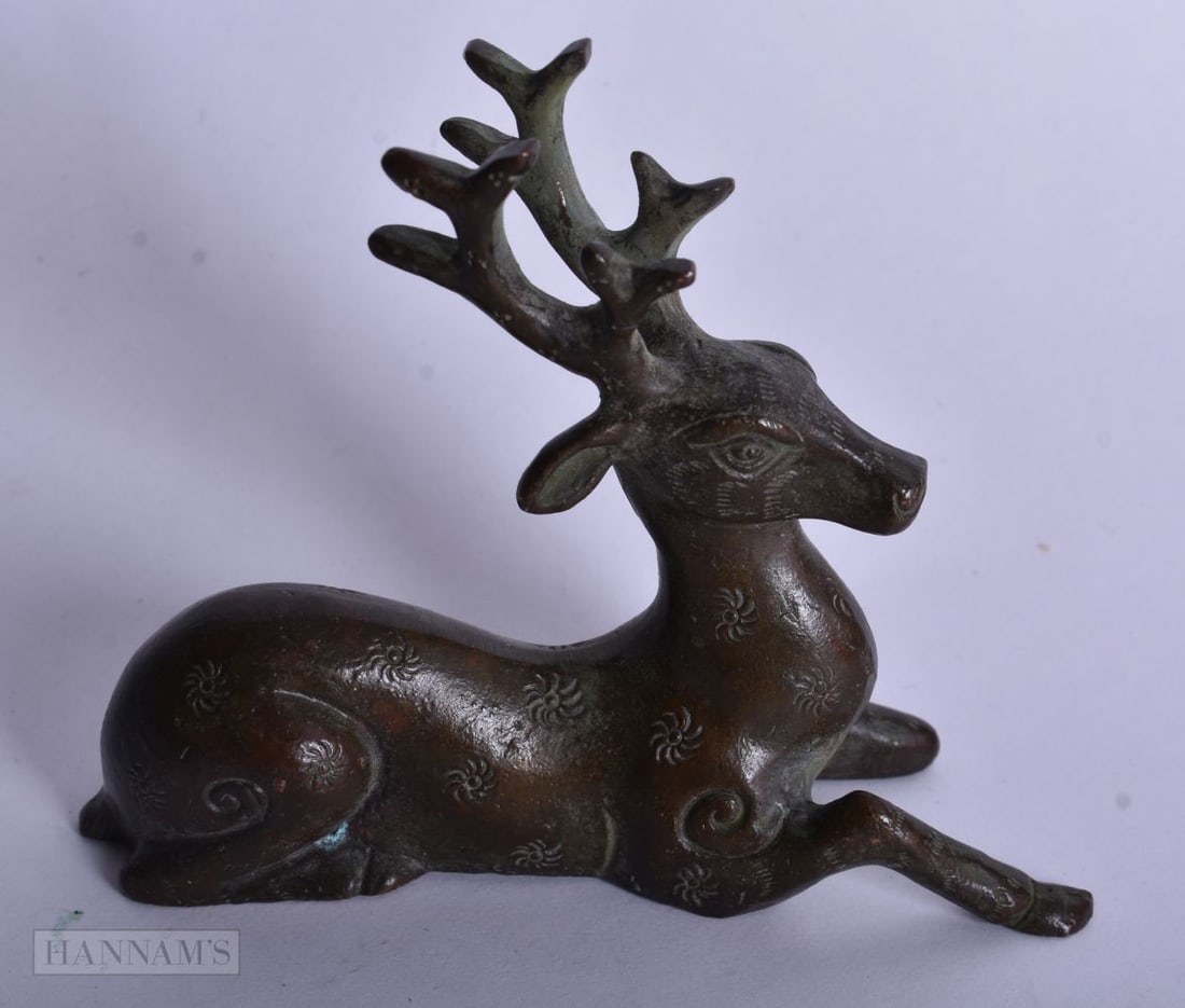 A CHINESE BRONZE DEER. 8 cm x 9.5 cm. (1 of 3)
