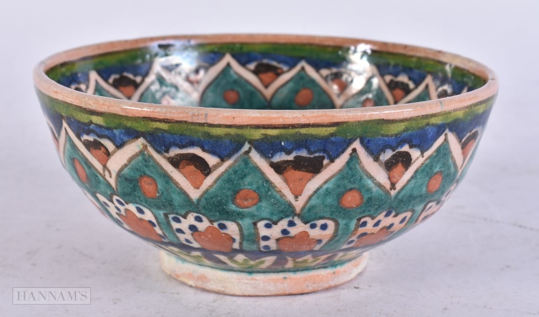 A MIDDLE EASTERN POTTERY BOWL. 12 cm wide. (1 of 3)