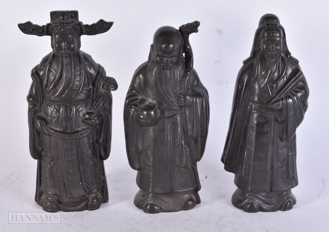 A SET OF THREE EARLY 20TH CENTURY CHINESE BRONZE IMMORTALS Late Qing/Republic. 21 cm high. (3): A SET OF THREE EARLY 20TH CENTURY CHINESE BRONZE IMMORTALS Late Qing/Republic. 21 cm high. (3)
