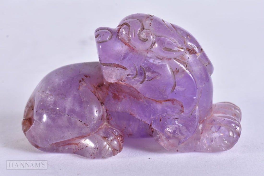A CHINESE CARVED AMETHYST FIGURE OF A BUDDHIST LION. 7 cm wide. (1 of 4)