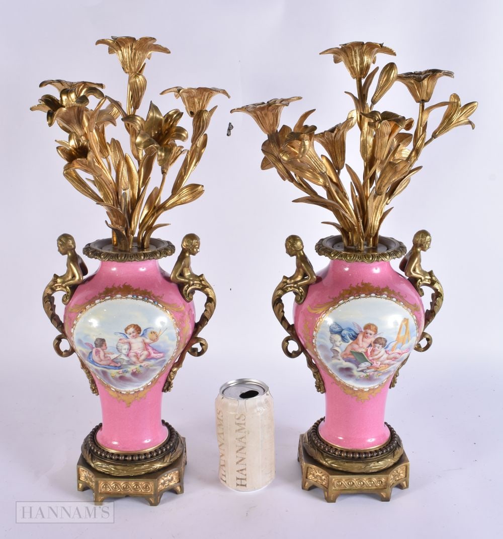 AN UNUSUAL PAIR OF 19TH CENTURY FRENCH SEVRES PORCELAIN ORMOLU CANDELABRA VASES painted with putti o: AN UNUSUAL PAIR OF 19TH CENTURY FRENCH SEVRES PORCELAIN ORMOLU CANDELABRA VASES painted with putti on a rose pompadour ground. 48 cm x 18 cm.