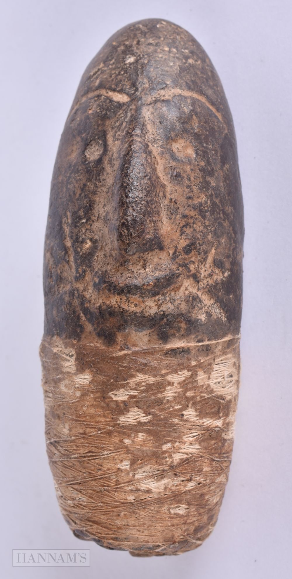 AN UNUSUAL ANTIQUE CARVED STONE TRIBAL HEAD possibly formerly part of a weapon or tool. 12 cm x 4.5: AN UNUSUAL ANTIQUE CARVED STONE TRIBAL HEAD possibly formerly part of a weapon or tool. 12 cm x 4.5 cm.