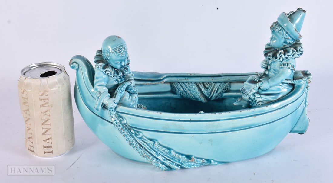 AN UNUSUAL 19TH CENTURY TURQUOISE GLAZED MODEL OF A BOAT modelled with figures. 32 cm x 18 cm. (1 of 4)