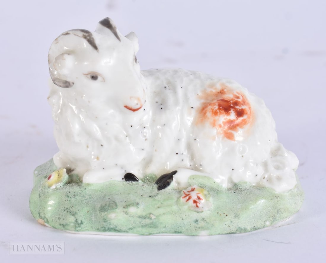 AN 18TH CENTURY ENGLISH PORCELAIN FIGURE OF A recumbent RAM. 6.5 cm x 4.5 cm.: AN 18TH CENTURY ENGLISH PORCELAIN FIGURE OF A recumbent RAM. 6.5 cm x 4.5 cm.