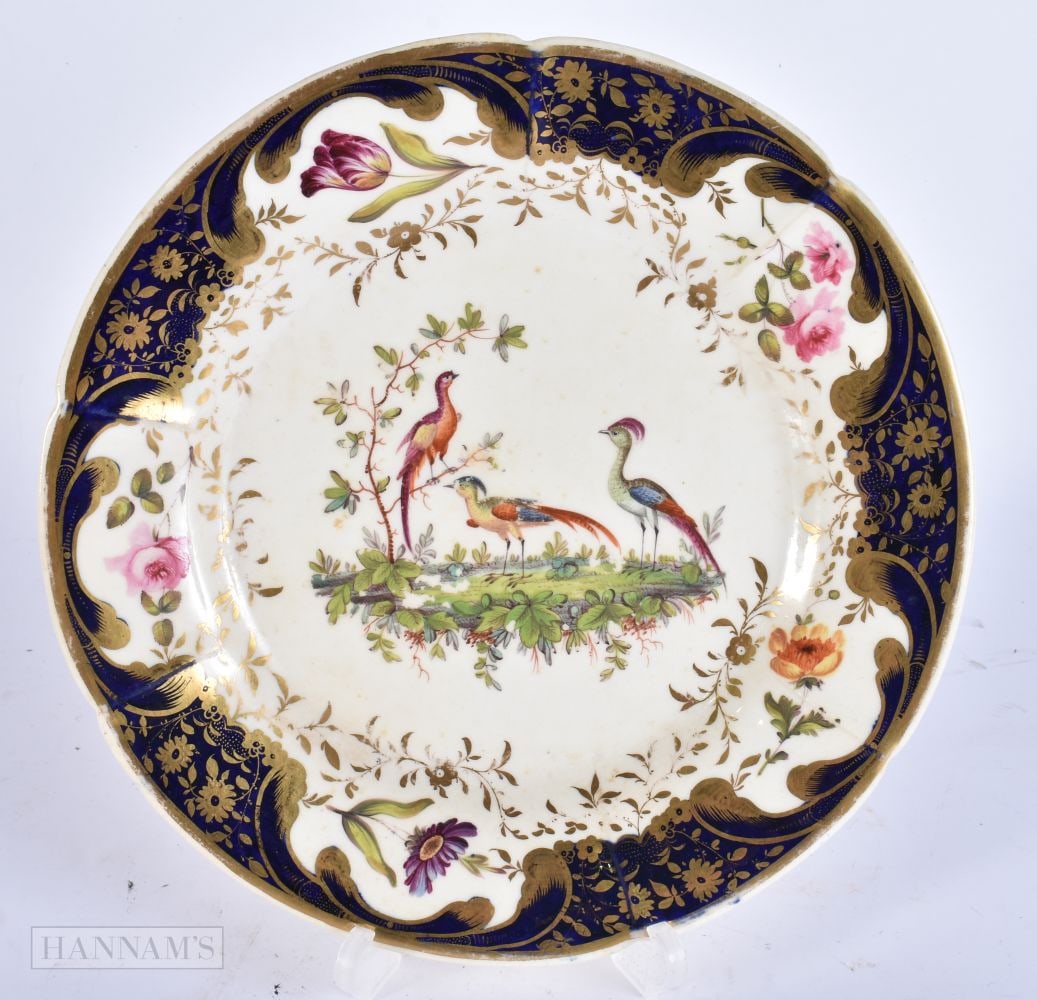 AN EARLY 19TH CENTURY ENGLISH PORCELAIN PLATE painted with exotic birds. 22 cm wide. (1 of 2)
