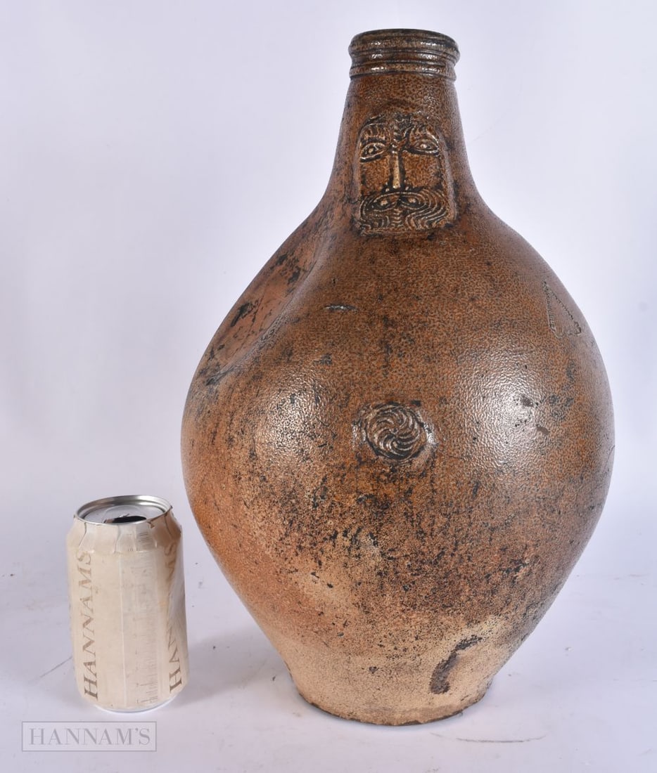 A CHARMING LARGE 17TH CENTURY GERMAN SALT GLAZED BELLARMINE JUG carved with mask heads and motifs. 3 (1 of 4)