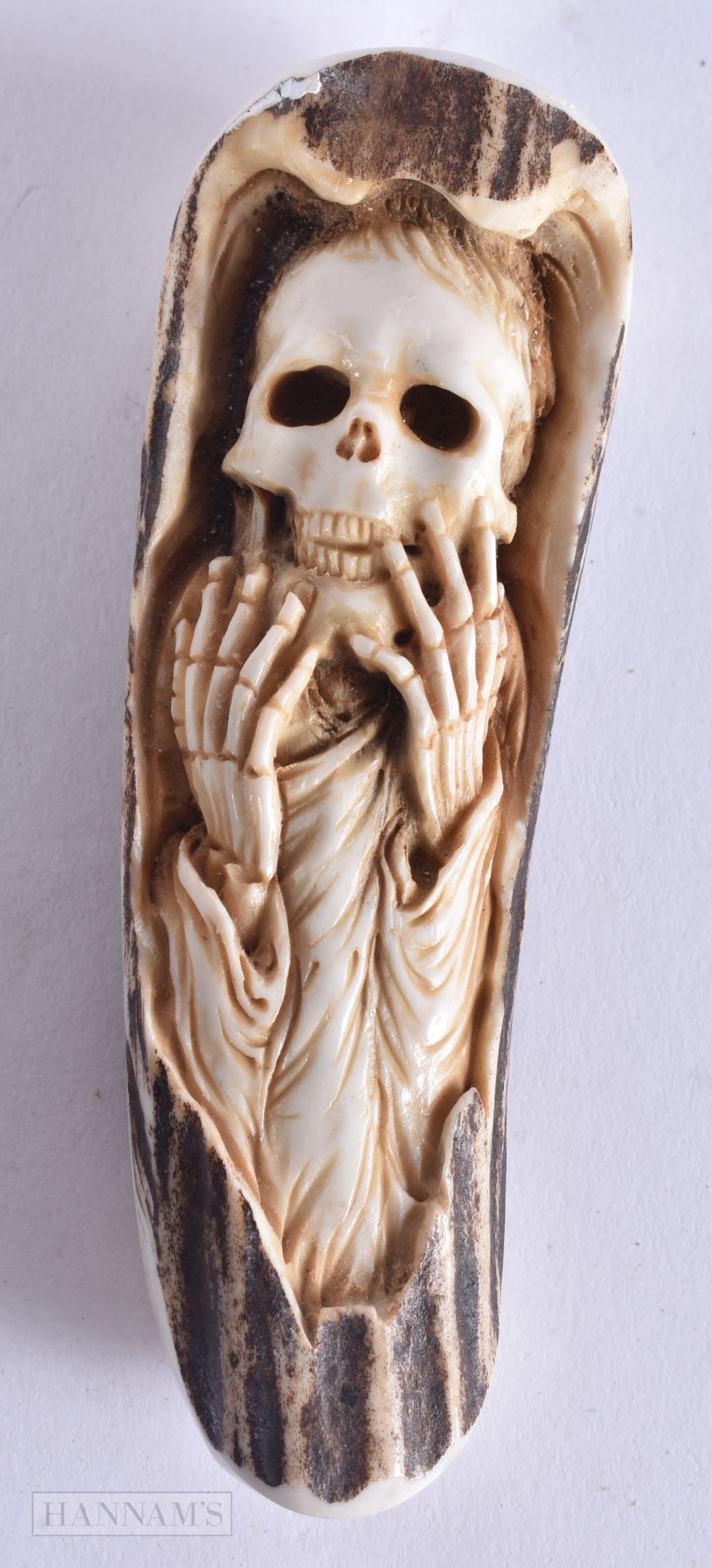 A STAG ANTLER MEMENTO MORI SKELETON. 56 grams. 10.25 cm high. (1 of 4)