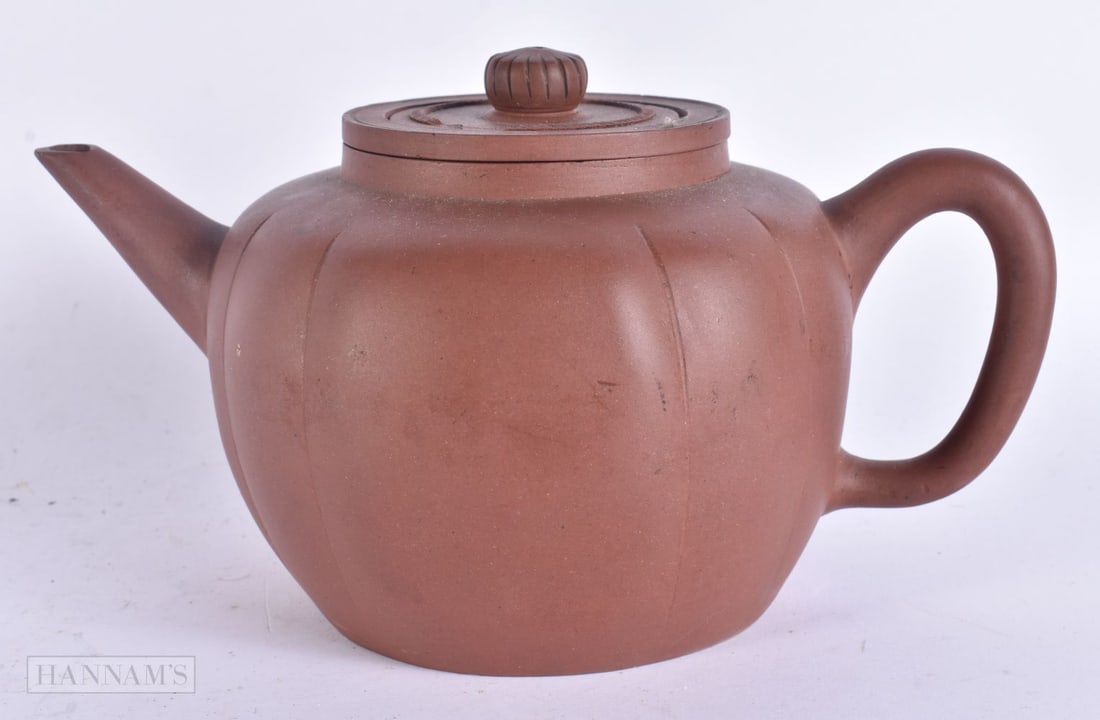 A 19TH CENTURY CHINESE YIXING POTTERY TEAPOT AND COVER Late Qing. 21 cm wide. (1 of 6)