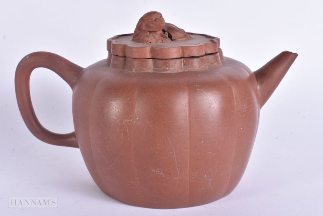 A 19TH CENTURY CHINESE YIXING POTTERY TEAPOT AND COVER Late Qing. 18 cm wide. (1 of 5)