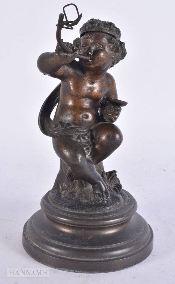 A 19TH CENTURY FRENCH GRAND TOUR PUTTI INKWELL modelled upon a pedestal base. 19 cm high.: A 19TH CENTURY FRENCH GRAND TOUR PUTTI INKWELL modelled upon a pedestal base. 19 cm high.