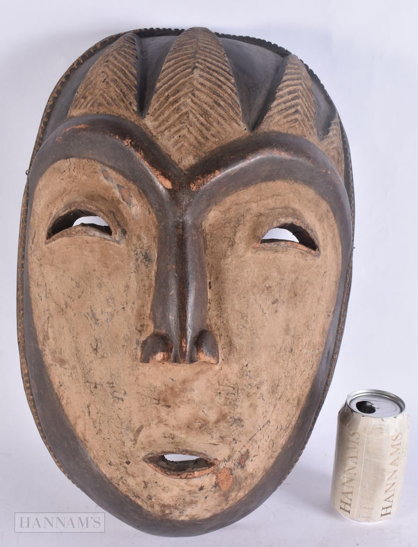 A LARGE AFRICAN FANG-STYLE NGIL MASK Gabon/Equatorial Guinea region, with pale kaolin-type pigment. (1 of 5)